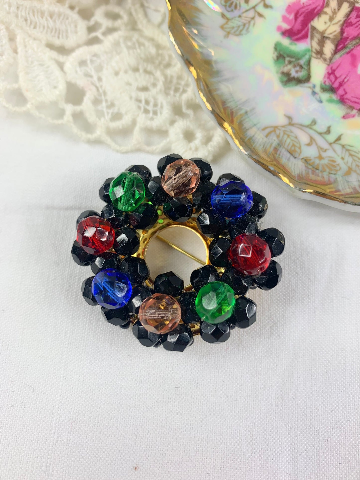 Broche vintage ronde à perles noires et colorées à facettes